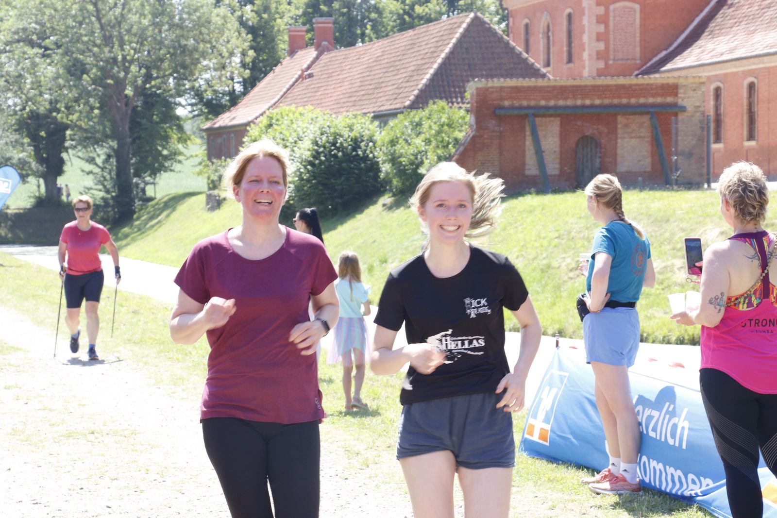 Zwei Läuferinnen laufen vor dem Schloss Bothmer in Klütz – Sonnenschein und gute Stimmung